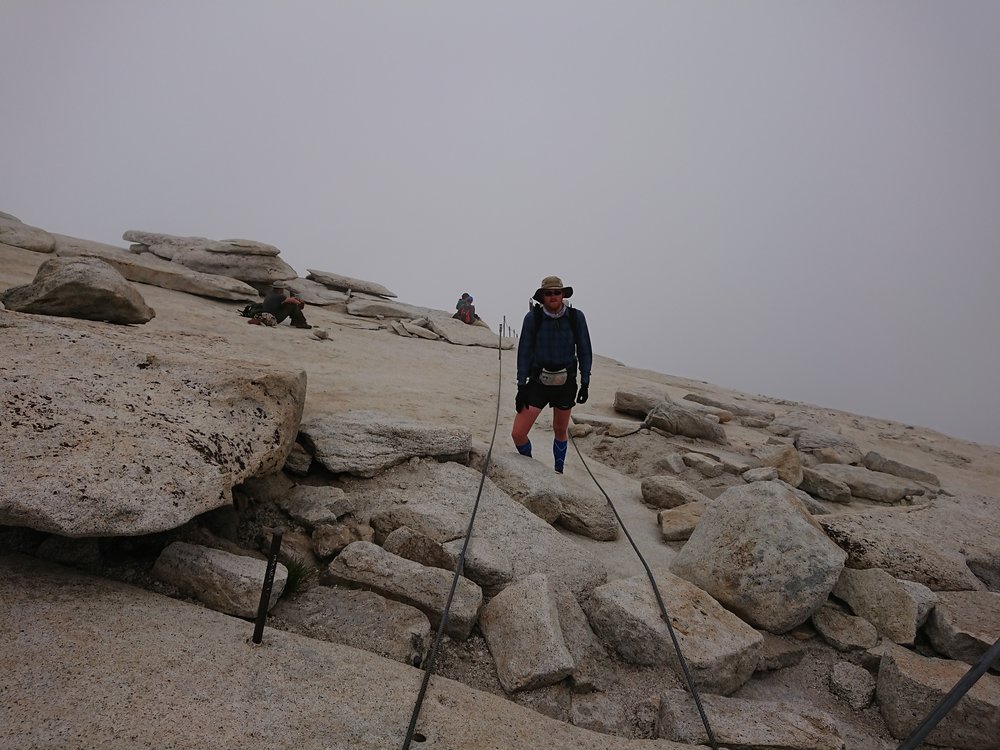  On the top of Half Dome completely envelope in clouds 