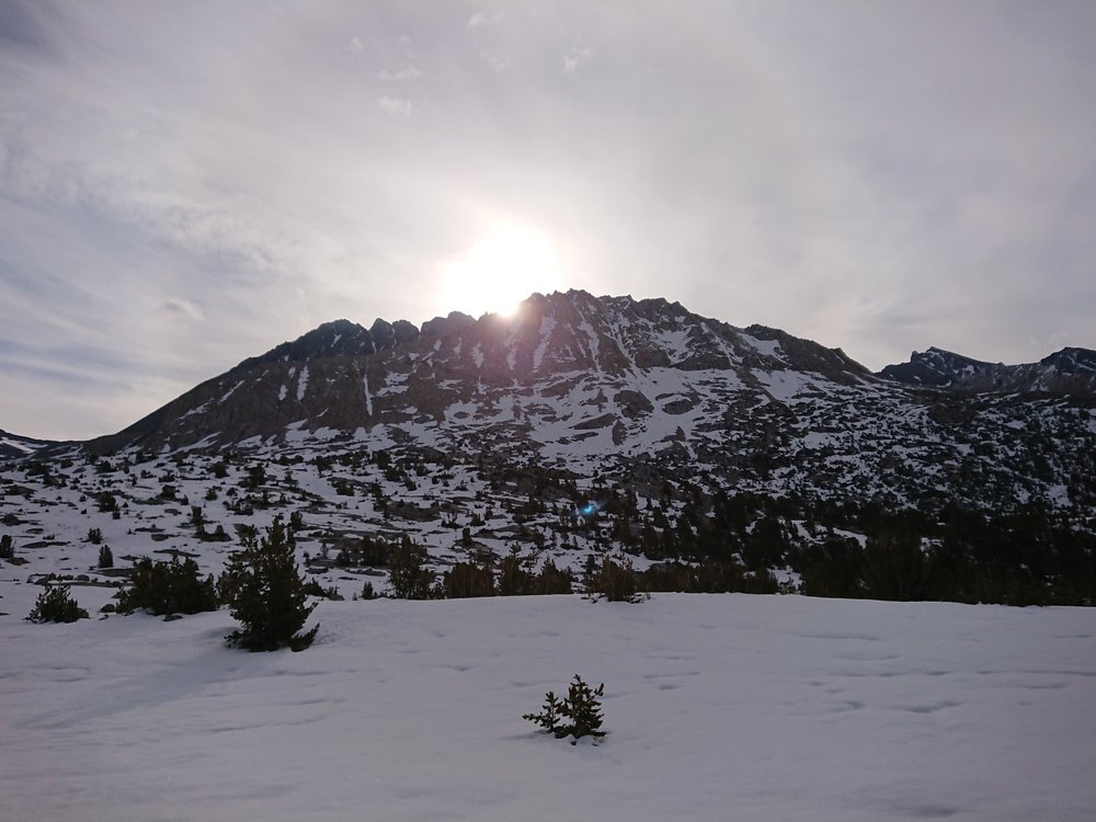  The sun is starting to show itself behind the surrounding mountains. 